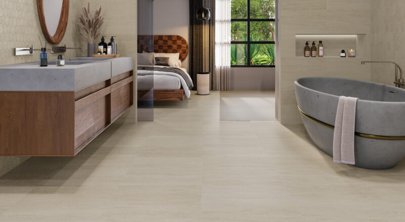 Portland stone-inspired Portland Cliff porcelain tile in hotel guest room bathroom