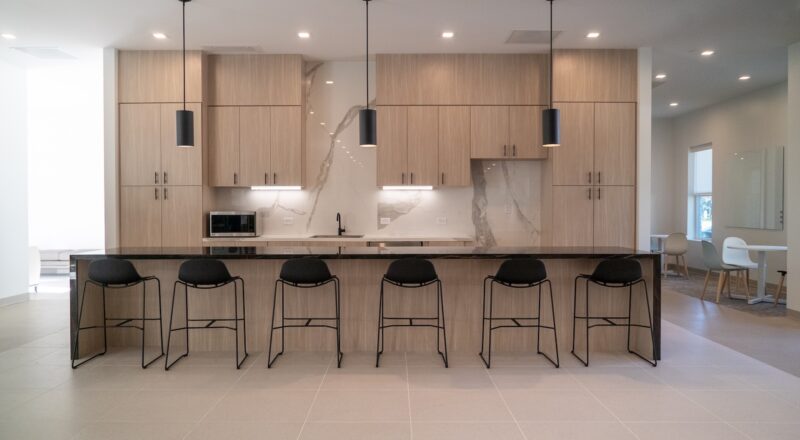 Songwon breakroom with CRossville tile on backsplash and porcelain panels on island and counters