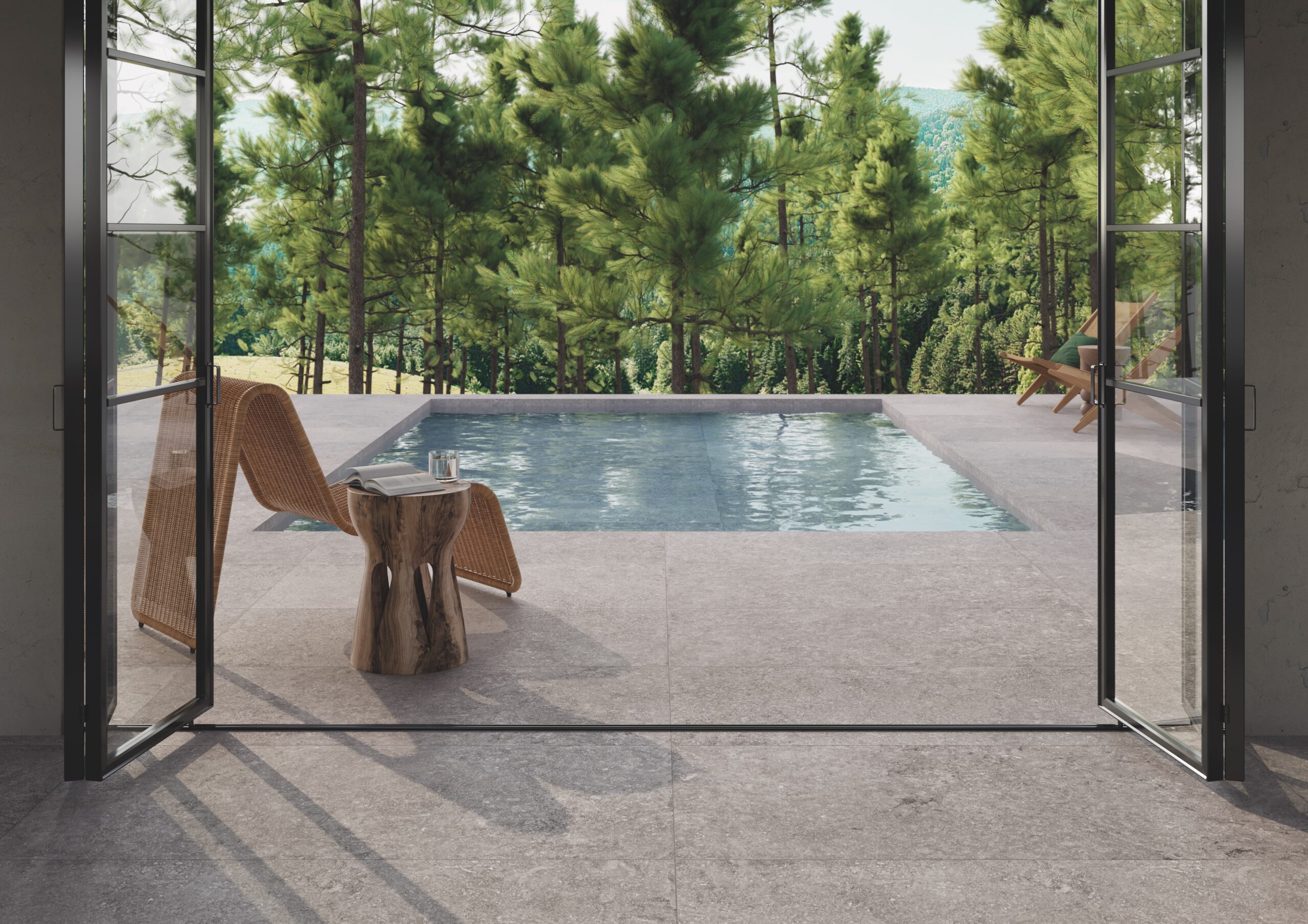 Pool decking with exterior finish Beljn, a Belgian limestone-inspired porcelain tile, with coordinating interior finish tiles for a seamless indoor-outdoor connection. 