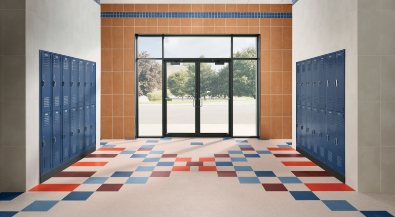 School hallway/entry with Armstrong resilient flooring and Crossville porcelain tile on walls