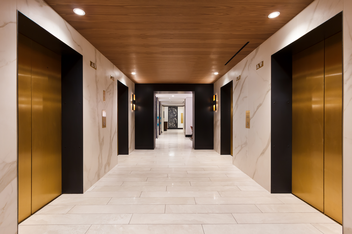 I Naturali porcelain panels in hotel elevator bank corridor on walls 